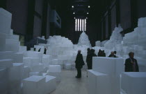 Tate Modern. Turbine Hall. Exhibition by Rachel Whiteread called Embankment. 14 000 transluscent white polyethylene boxes stacked in various ways.Visitors walking around.