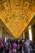 Vatican City Museum Tourists in the Gallery of Maps showing the illuminated ceiling and the walls lined with 16th Century cartography