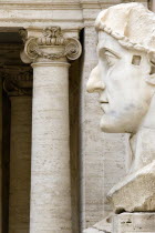 The Capitoline Museum Palazzo dei Conservatori The head of a colossal marble staue of the Roman Emperor Constantine the First with Ionic columns beyond