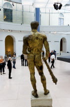 The Capitoline Museum palazzo dei Conservatori. Visitors view the 2nd Century BC gilded bronze statue of Hercules in the Portico of Marcus Aurelius