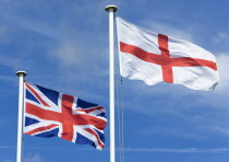 Flagpoles with the English flag of Saint George on the right with the Union Flag or Union Jack of Great Britain on the left