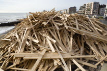 Timber washed up on the beach from the Greek registered Ice Princess which sank off the Dorset coast on 15th January 2008. Seafront flats beyond