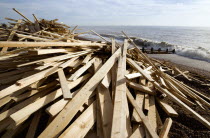 Timber wood planks washed up on the beach seafront from the wreckage of the Greek registered ship Ice Princess which sank off the Dorset coast on 15 January 2008