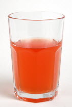 Soda glass containing light red soft drink