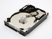 Open computer hard drive showing disc and read write mechanism