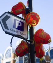 Lion Dance troupe and musicians performing in Wardour Street amongst the crowd outside restaurants during Chinese New Year celebrations in 2006 for the coming Year of The Dog