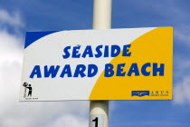 Seafront sign of a Seaside Award Beach from the Encams Keep Britain Tidy campaign on the seafront promenade