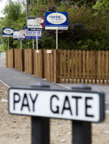 To Let and For Sale signs on wooden fencing outside a newly built housing development in a road called Pay Gate