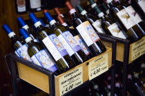 ITALY, Tuscany, San Gimignano, Bottles of Chianti and Vernaccia di San Gimignano wines displayed for sale outside a wine shop or enoteca with prices given in Euros.
