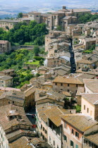 ITALY, Tuscany, Siena View over rooftops and gardens with a narrow winding medieval street towards the countryside to the west of the city.