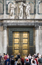 ITALY, Tuscany, Florence, Tourists in front of the 15th Century East Door of the Baptistry by Lorenzo Ghilberti, given the name The Gate of Paradise by Michelangelo.