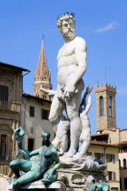 ITALY, Tuscany, Florence The 1575 Mannerist Neptune fountain, with the Roman sea God surrounded by water nymphs commemorating Tuscan naval victories, by Ammannatti in the Piazza della Signoria beside...