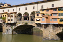 ITALY, Tuscany, Florence, The 14th Century Ponte Vecchio medieval bridge across the River Arno showing the backs of the goldsmiths workshops that hang over the water.