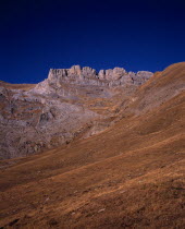 Sierra de la Escusana.  Mountain landscape with eroded rock pinnacles and layers of rock and scree.