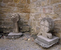 Montmaur.  Disc shaped crosses outside the Eglise St Baudile thought to be associated with the Cathars.