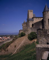 Carcassonne.  Gateway in medieval fortified outer walls of town with the Counts Chateau behind.