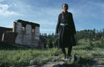 Portrait of gatekeeper at ruined monastery complex undergoing restoration since the collapse of communism and restoration of religious freedom.