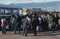 Waiting crowd at bus station in northern town.