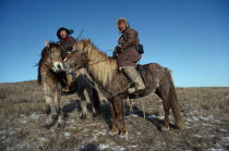 Two wolf hunters on Mountredon ponies in the autumn with frost on the ground