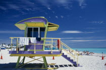 South Beach. Colourful Lifeguard Station on sandy beach with sunbathers near turquoise sea