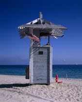 Lifeguard Hut on sandy beach with American flag flying