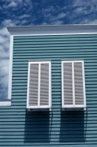Building exterior with detail of shutters on windows