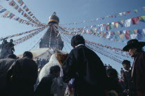 Crowds surrounding Bodhanath stupa hung with prayer flags during Loshar  the Tibetan New Year.