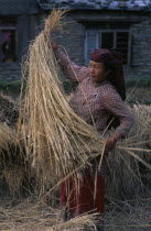 Woman in traditional dress with straw.
