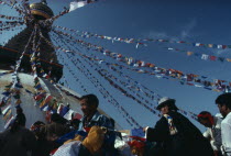 Tibetans hanging the stupa with prayer flags for new year celebrations.