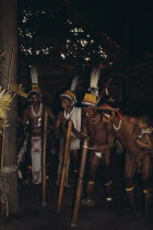 Barasana stave dance.  Line of male dancers wearing body paint and feather head-dresses.Tucano sedentary Indian tribe Western Amazonia American Colombian Columbia Hispanic Kids Latin America Latino P...