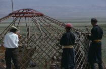 Khalkha herdsmen erecting the family ger or yurt on pastureland of Bigersum  Freedom negdel collective.First the frame must be set in the ground.  .Khalha East Asia Asian Mongol Uls Mongolian