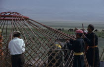 Bigersum  Freedom negdel collective  Khalkha herdsmen building a ger or yurt on summer grassland pastures.  First erecting the frame.Khalha East Asia Asian Mongol Uls Mongolian