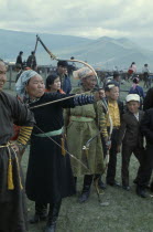 Nadam  National Day Ulan Bator Stadium Woman competitor taking part in national archery competition.Ulaanbaatar East Asia Asian Baator Female Woman Girl Lady Mongol Uls Mongolian Ulaan