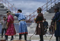 Nadam  National Day Ulan Bator stadium  three veteran competitors taking part in national archery competition.Ulaanbaatar East Asia Asian Baator Mongol Uls Mongolian Ulaan