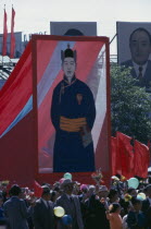 Nadam  Mongolian National Day. Parade of Communist Party members and workers carrying banners and posters of the first Mongolian President Sukhebator in foreground and other important Mongolian politb...