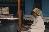 Khalkha winter sheep camp. Shepherds wife cooking traditional meat dumplings over normal iron stove inside ger yurt for Tsagaan Tsaar Lunar New Years celebrations