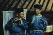 Flute player and chanter in traditional costume during celebrations for the Mongolian Lunar New Year or Tsagaan Tsaar.East Asia Asian Classic Classical Historical Mongol Uls Older