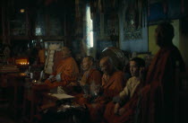 Ulan Bator Buddhist temple  the only one the Russian dominated Mongol government allowed to exist and be used for worship  in 1970s  Buddhist monks praying in low natural light.