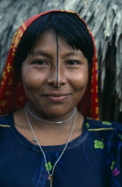 Portrait of smiling Kuna woman with gold nose ring and black line drawn along length of nose thought to enhance beauty.Cuna Caribbean American Central America Female Women Girl Lady Hispanic Latin Am...