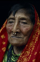 Head and shoulders portrait of elderly Kuna woman wearing long head scarf and traditional gold nose ring.Cuna Caribbean American Central America Classic Classical Female Women Girl Lady Hispanic Hist...