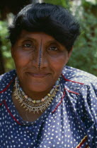 Portrait of  wife of Kuna headman traditional black stripe drawn down length of nose thought to enhance beauty  bead and monkey teeth necklace  banded bead designs on armsCuna Caribbean American Cent...