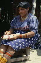 Older Kuna Indian woman preparing traditional bead design.  Note colourful beads worn around ankles  calves  wrists and forearmsCuna Caribbean American Central America Colorful Female Women Girl Lady...