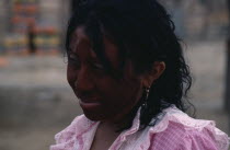 Head and shoulders portrait of Guajira woman with face painted dark red  ochote fruit  and black with a mixture of goats fat and charcoal as protection against sun and strong sea winds.Wayu Wayuu Gua...