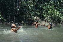 Three young Makuna children playing in water at the malocas river port.Tukano Indian North Western Amazonia American Colombian Columbia Hispanic Indegent Kids Latin America Latino South America Tukan...