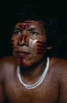 Head and shoulders portrait of Venancio Makuna  Ignacios son  with ceremonial dark red ochote facial paint. Tukano Makuna Indian North Western Amazonia American Colombian Columbia Hispanic Indegent La...