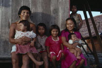 Makuna family - Venancio one of headman Bosco sons  with his wife and five children outside their recently constructed small family home. Venancio is the teacher in the local Makuna school   Makuna In...