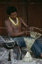 Makuna man making cane cooking pot stands.Tukano  Makuna Indian North Western Amazonia American Colombian Columbia Hispanic Indegent Latin America Latino Male Men Guy South America Tukano