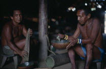 Makuna headman Ignacio taking powdered coca  refined and pounded through barkcloth bag. Tukano  Makuna Indian North Western Amazonia American Colombian Columbia Hispanic Indegent Latin America Latino...