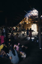 Makuna maloca or tribal communal home  interior with Makuna Indian families sharing communal meal of fish and casabe/manioc bread  family fireplaces in background.Tukano  Makuna Indian North Western A...