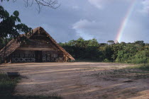 Makuna communal tribal or maloca with decorated exterior and cleared dance area in the foreground.Tukano Makuna Indian North Western Amazonia maloca American Colombian Columbia Hispanic Indegent Lati...